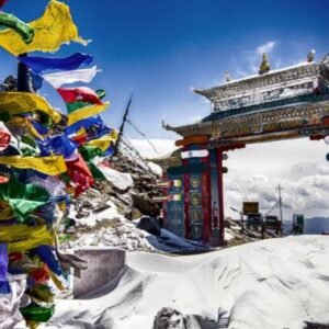 Snow-covered mountain gateway and colourful prayer flags in Arunachal Pradesh